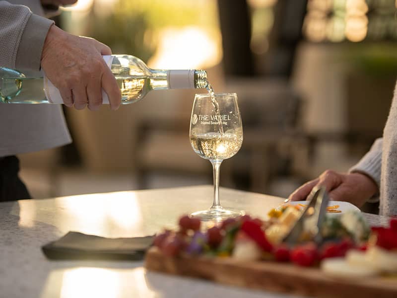 Pouring glass of white wine.